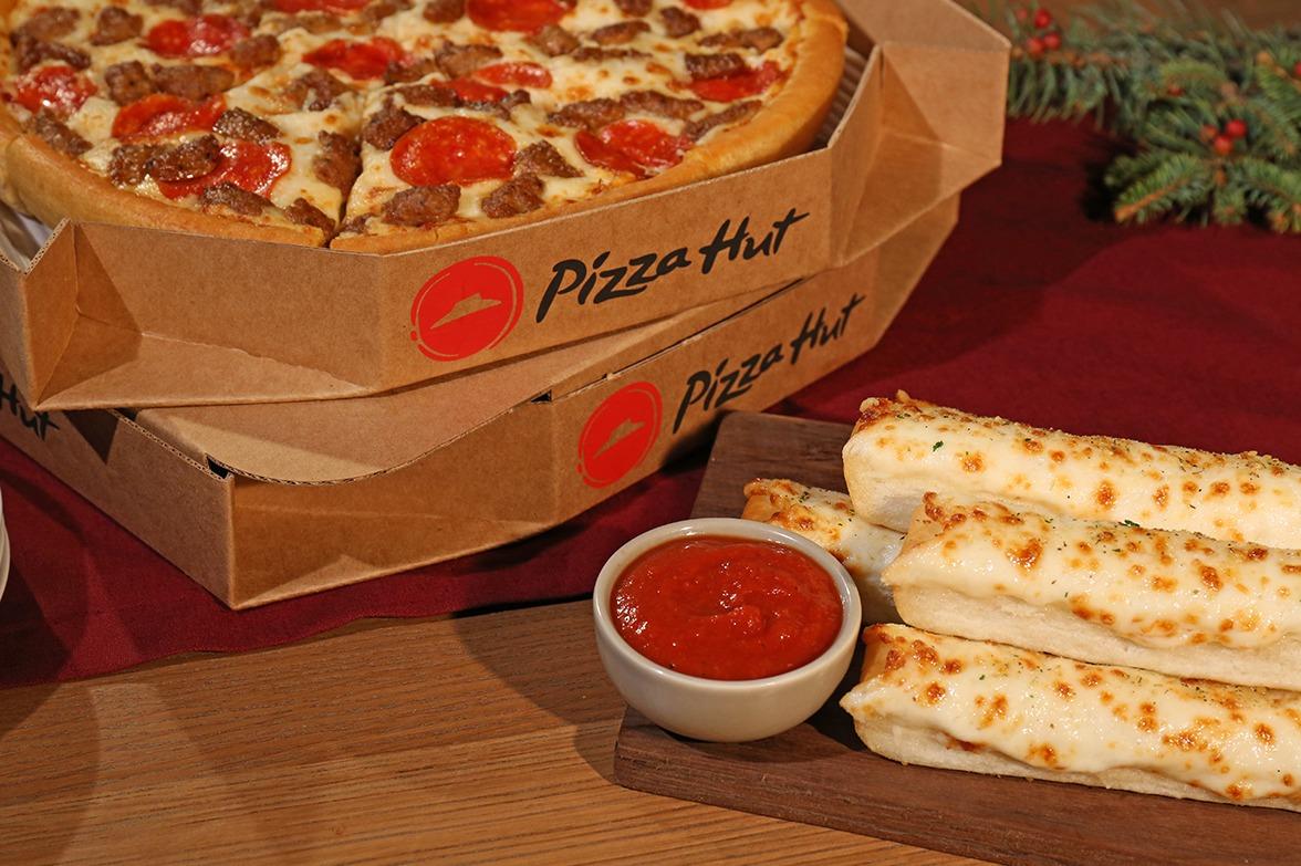 2 pizzas in boxes breadsticks and marinara sauce