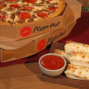 2 pizzas in boxes breadsticks and marinara sauce